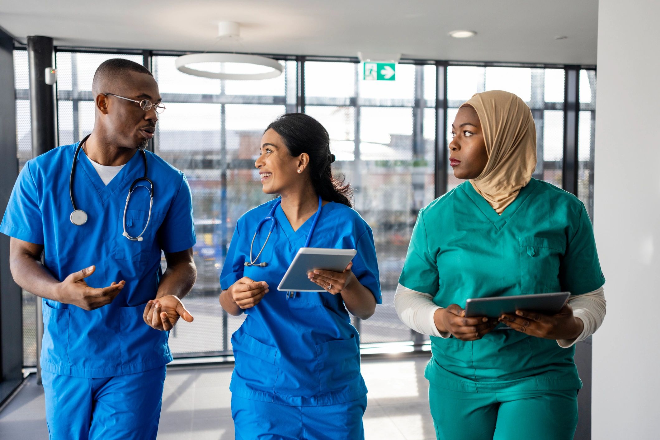 Healthcare professionals walking through a medical facility