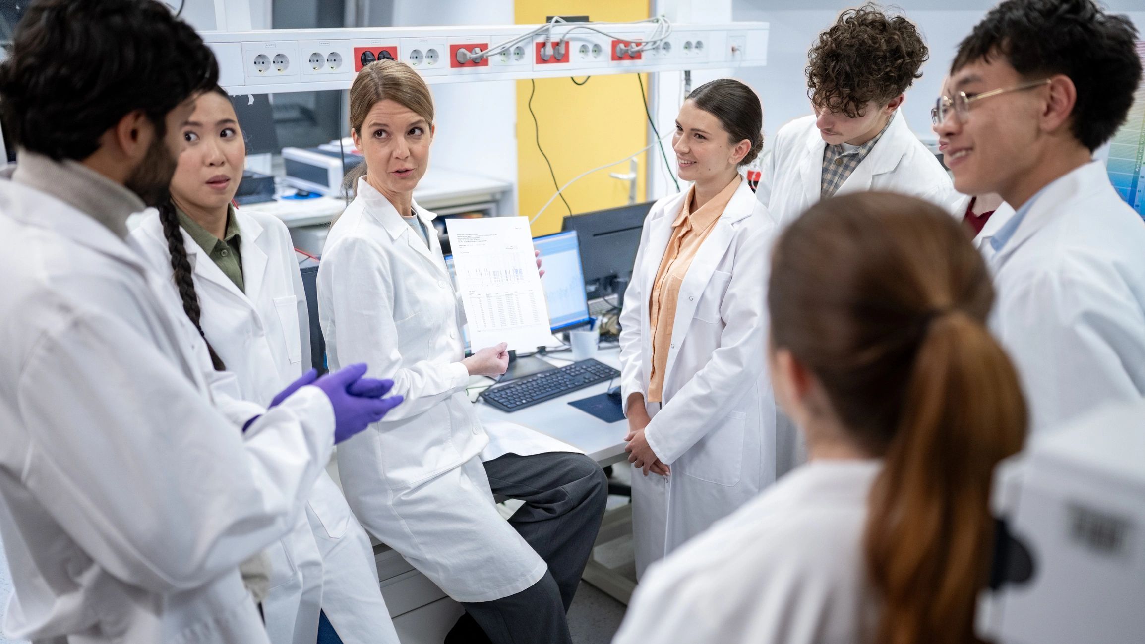 Healthcare professionals discussing research in a laboratory